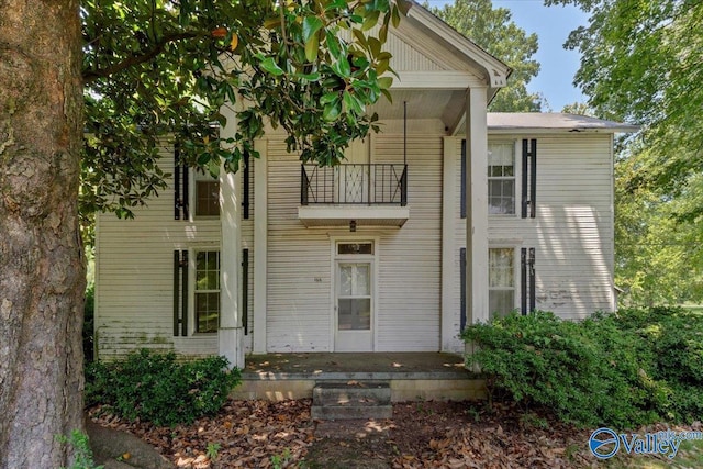 view of front of home featuring covered porch and a balcony