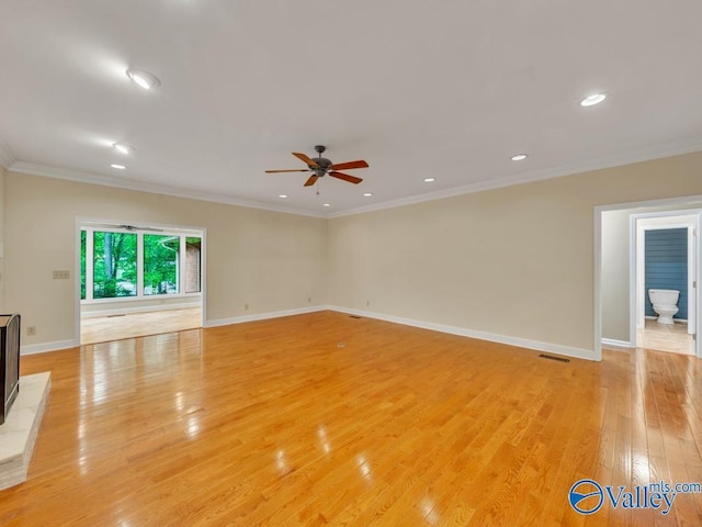 spare room with light wood finished floors, recessed lighting, ceiling fan, baseboards, and ornamental molding