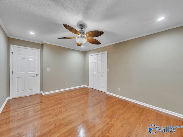 unfurnished room with light wood-style flooring, baseboards, recessed lighting, ornamental molding, and a ceiling fan