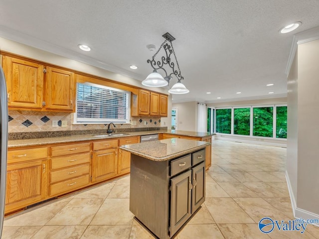 kitchen featuring a kitchen island, backsplash, crown molding, and a sink