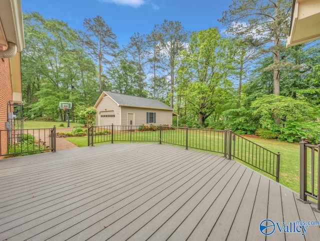wooden deck with an outdoor structure, a lawn, and a detached garage