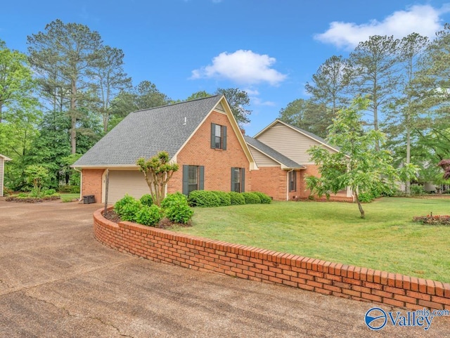 view of home's exterior with a yard, a shingled roof, and brick siding