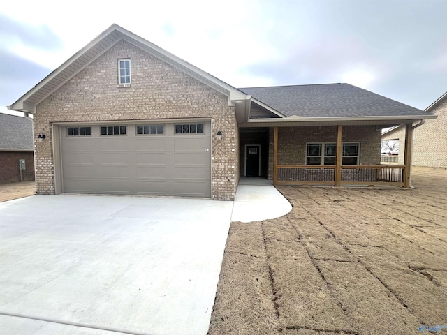 view of front of property with covered porch and a garage