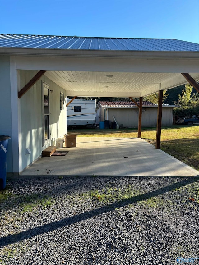 view of car parking featuring a yard and a carport