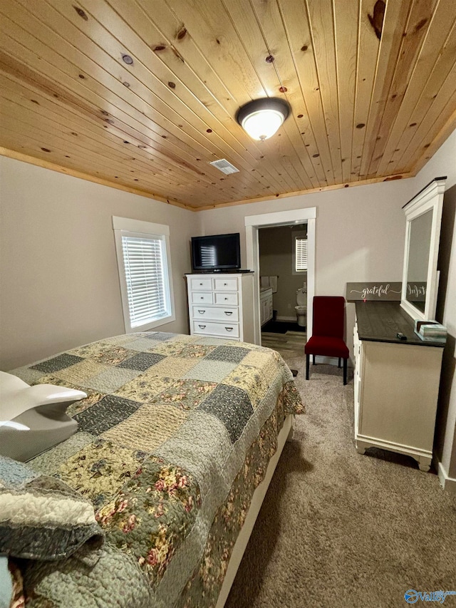 carpeted bedroom featuring ensuite bath and wooden ceiling