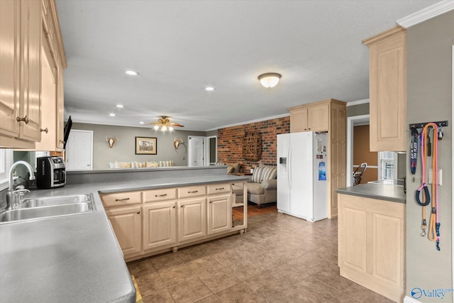 100 Cumberland Cir, Scottsboro, AL 35769 - kitchen with white refrigerator with ice dispenser, a sink, a peninsula, light brown cabinets, and ornamental molding