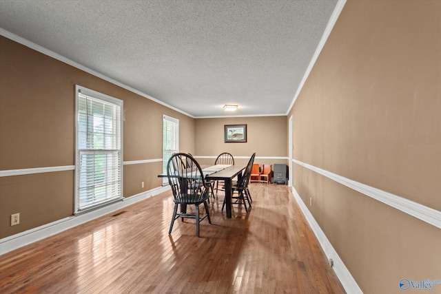 100 Cumberland Cir, Scottsboro, AL 35769 - dining space featuring a textured ceiling, ornamental molding, and hardwood / wood-style floors