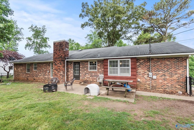 100 Cumberland Cir, Scottsboro, AL 35769 - rear view of house featuring a patio, brick siding, a yard, and a chimney