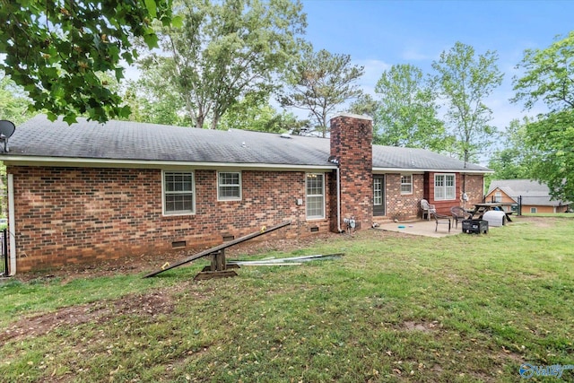 100 Cumberland Cir, Scottsboro, AL 35769 - rear view of property featuring a chimney, brick siding, a patio area, crawl space, and a yard