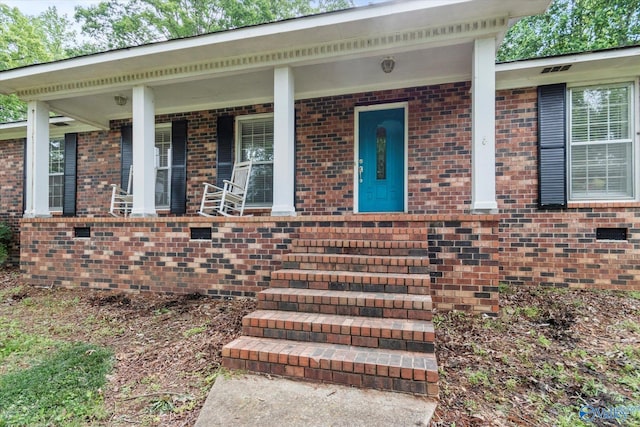 100 Cumberland Cir, Scottsboro, AL 35769 - view of exterior entry with brick siding and a porch