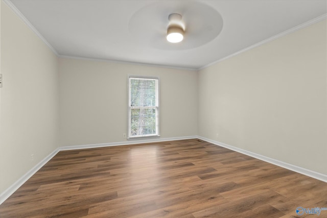 unfurnished room featuring ceiling fan, ornamental molding, and dark hardwood / wood-style flooring