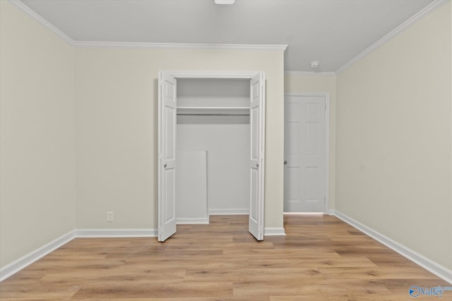 unfurnished bedroom featuring crown molding, a closet, and light hardwood / wood-style floors