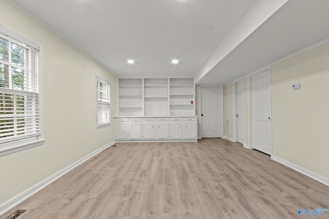 spare room with crown molding and light hardwood / wood-style floors