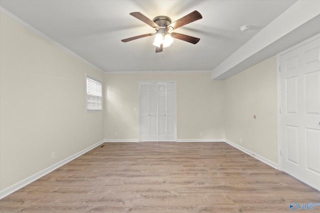 unfurnished room with crown molding, ceiling fan, and light wood-type flooring