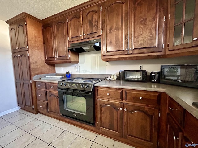 kitchen with light tile patterned floors, a textured ceiling, and black appliances