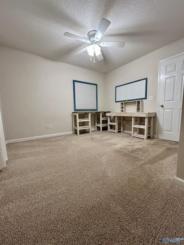 carpeted home theater with ceiling fan and a textured ceiling