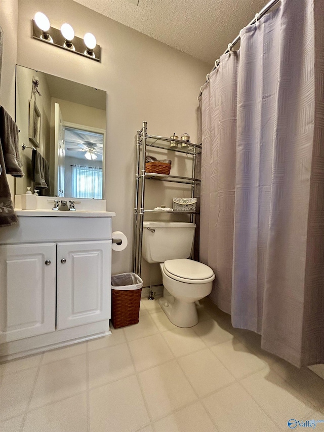 bathroom featuring vanity, a textured ceiling, and toilet