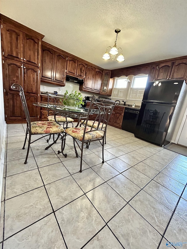 kitchen with black appliances, decorative light fixtures, light tile patterned floors, and an inviting chandelier