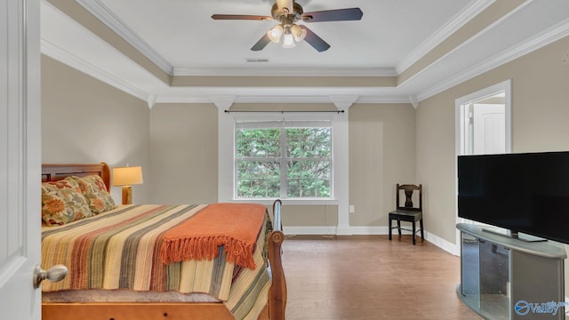24147 Jacobs Dr, Athens, AL 35613 - bedroom with wood finished floors, a raised ceiling, baseboards, crown molding, and a ceiling fan