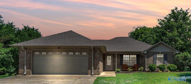 24147 Jacobs Dr, Athens, AL 35613 - view of front of house with concrete driveway, brick siding, a garage, and a front yard