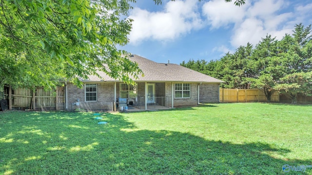 24147 Jacobs Dr, Athens, AL 35613 - back of property with brick siding, a patio area, and roof with shingles