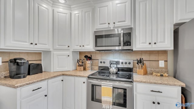 24147 Jacobs Dr, Athens, AL 35613 - kitchen with appliances with stainless steel finishes, white cabinets, tasteful backsplash, and light stone counters