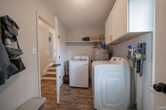 609 Mountain Gap Dr, Huntsville, AL 35083 - laundry area with electric water heater, wood finished floors, cabinet space, washing machine and clothes dryer, and a textured ceiling