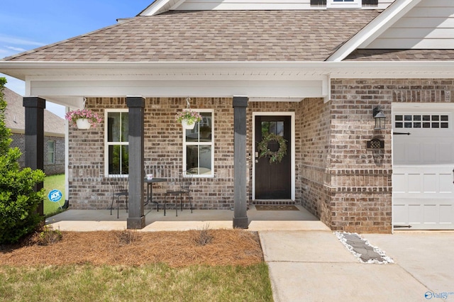 property entrance with a porch, brick siding, roof with shingles, and a garage