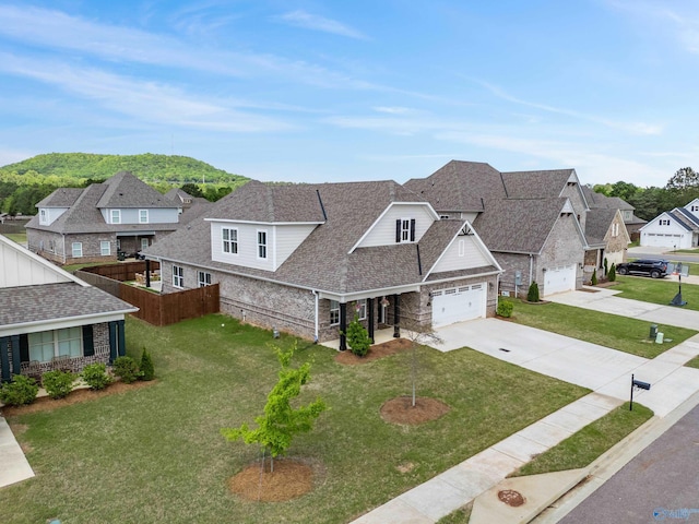 view of front of home with concrete driveway, a residential view, a front yard, and a garage