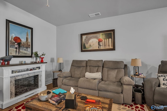 living room featuring hardwood / wood-style flooring and a high end fireplace