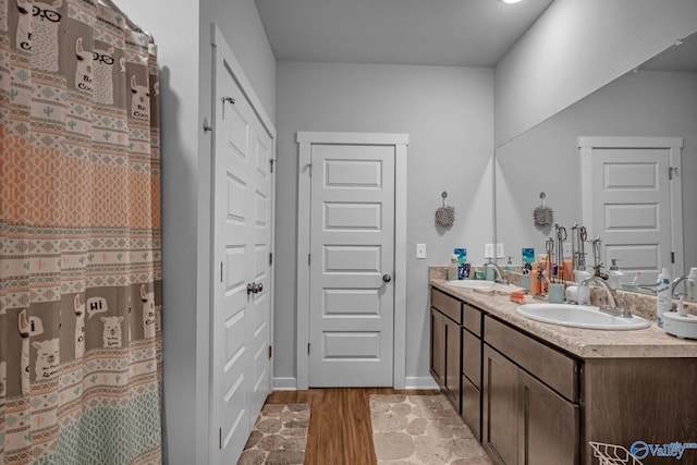 bathroom with vanity and wood-type flooring