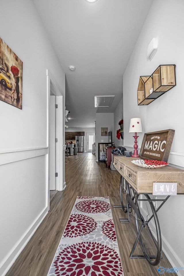 hallway with dark hardwood / wood-style flooring