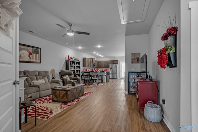 living room with ceiling fan and wood-type flooring