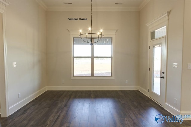 unfurnished dining area with dark wood finished floors, a healthy amount of sunlight, crown molding, and an inviting chandelier