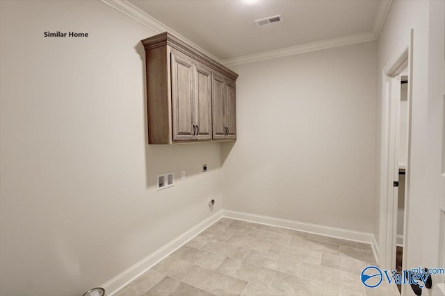 washroom with crown molding, hookup for an electric dryer, cabinet space, baseboards, and visible vents