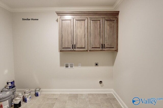 laundry room with hookup for an electric dryer, baseboards, cabinet space, hookup for a washing machine, and crown molding