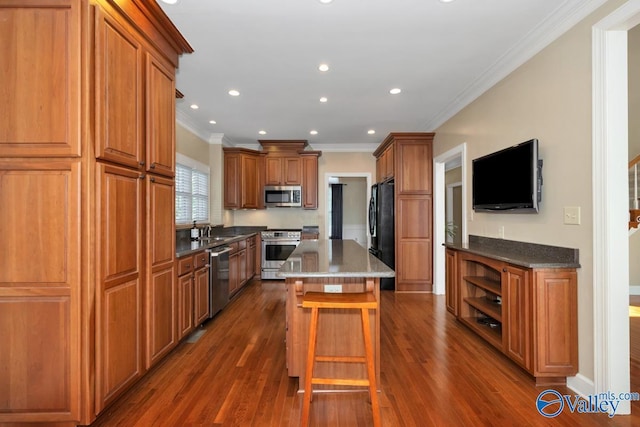 412 Clydebank Dr, Madison, AL 35758 - kitchen featuring stainless steel appliances, crown molding, a center island, brown cabinetry, and dark wood-type flooring