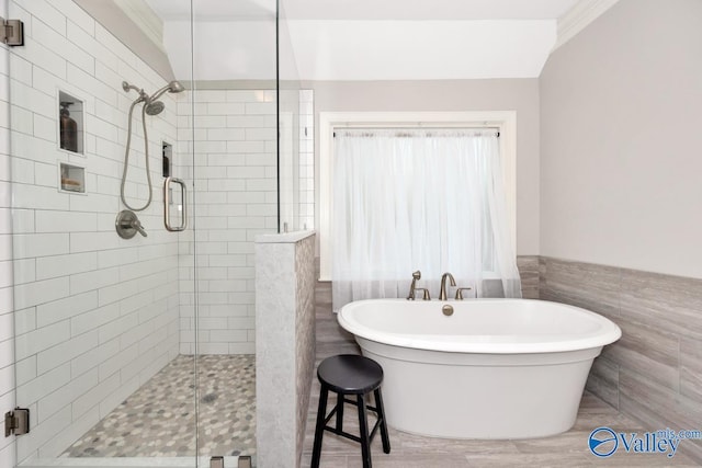 412 Clydebank Dr, Madison, AL 35758 - bathroom with a stall shower, a freestanding tub, tile walls, and a wainscoted wall
