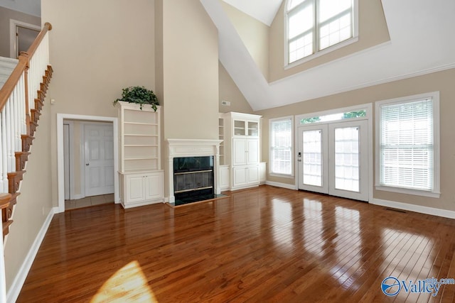 412 Clydebank Dr, Madison, AL 35758 - unfurnished living room featuring high vaulted ceiling, hardwood / wood-style flooring, stairway, baseboards, and a premium fireplace