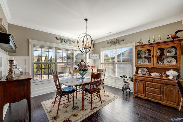 dining room with a healthy amount of sunlight, an inviting chandelier, and dark hardwood / wood-style flooring