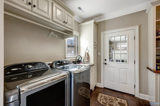 laundry room featuring sink, washing machine and clothes dryer, cabinets, dark hardwood / wood-style flooring, and crown molding