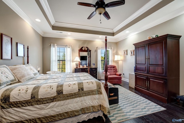 bedroom featuring crown molding, ceiling fan, a tray ceiling, and dark hardwood / wood-style floors