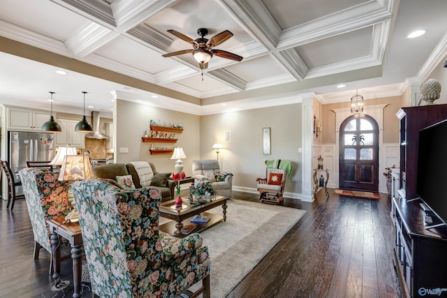 living room featuring dark wood-type flooring, ceiling fan with notable chandelier, coffered ceiling, crown molding, and beam ceiling