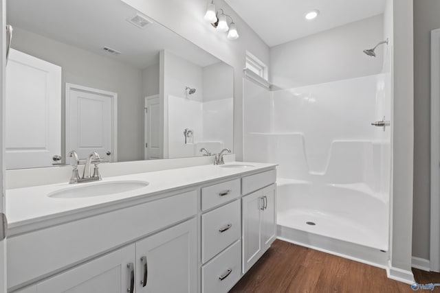 148 Aurora Cir, Fayetteville, TN 37334 - full bathroom with double vanity, a shower, wood finished floors, and recessed lighting