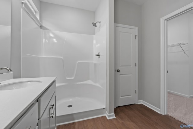 148 Aurora Cir, Fayetteville, TN 37334 - bathroom with wood finished floors, a shower, baseboards, vanity, and a walk in closet