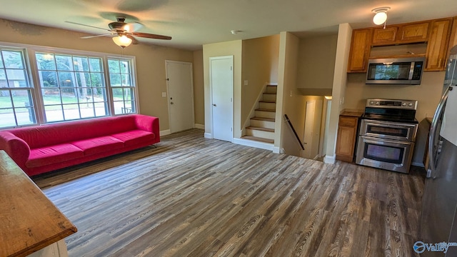 3703 Fox Trail Cir, Huntsville, AL 35810 - living room with dark wood-style floors, a ceiling fan, stairway, and baseboards