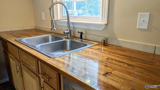 3703 Fox Trail Cir, Huntsville, AL 35810 - kitchen with a sink, brown cabinetry, and wooden counters
