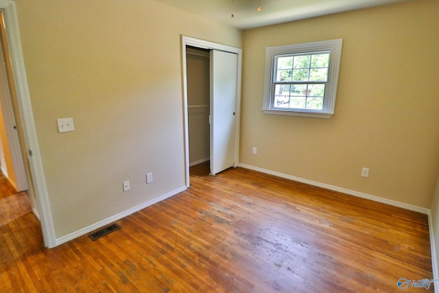 3703 Fox Trail Cir, Huntsville, AL 35810 - unfurnished bedroom featuring wood finished floors, baseboards, and a closet