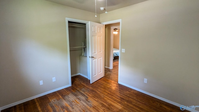 3703 Fox Trail Cir, Huntsville, AL 35810 - unfurnished bedroom with baseboards, dark wood-style flooring, and a closet