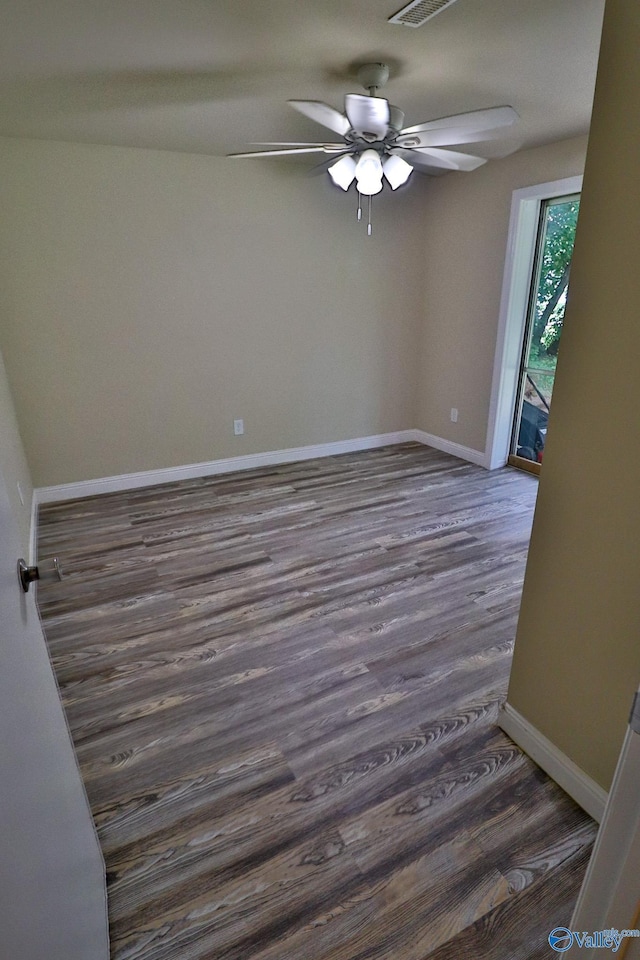 3703 Fox Trail Cir, Huntsville, AL 35810 - empty room with dark wood finished floors, a ceiling fan, and baseboards